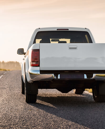 White ute pulled over on country road.
